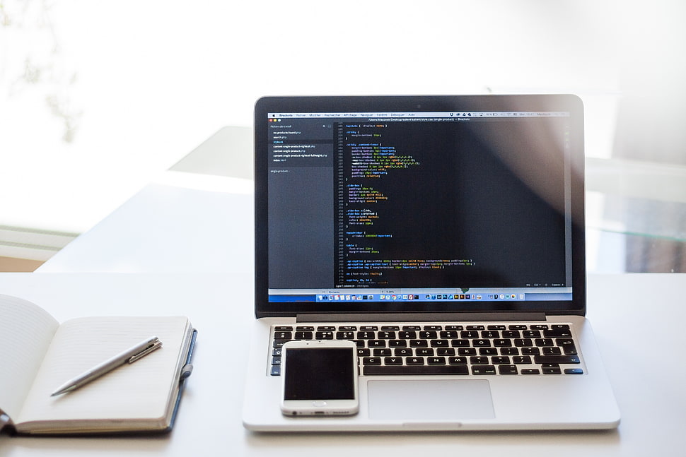 white smartphone on MacBook Pro HD wallpaper