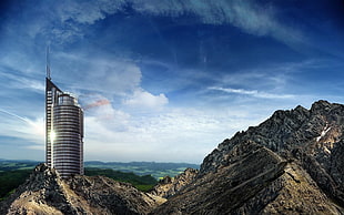 landscape photo of building near rocks HD wallpaper