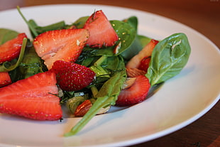 sliced Strawberries serve on white ceramic plate