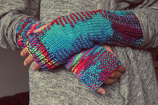 woman wearing gray cardigan and multicolored gloves