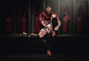 soccer player wearing red and black crew-neck t-shirt and white shorts