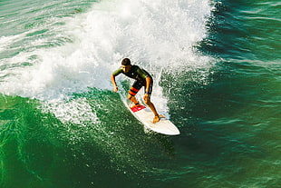 man on white surfing board on body of water during daytime HD wallpaper