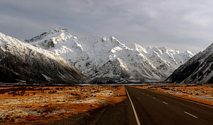 concrete road in a distance of glacier mountain, mt cook, nz