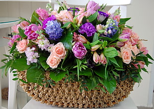 Roses and Lilies arrangement with brown crochet basket HD wallpaper