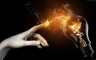 person's hand touching electricity from an incandescent bulb digital wallpaper