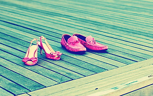 two pair of red heeled sandals and loafers on wooden floor