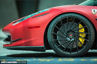 red Ferrari sports car on black top road