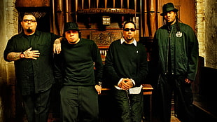 group of four men in black shirt