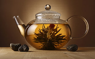 clear glass teapot filled with tea
