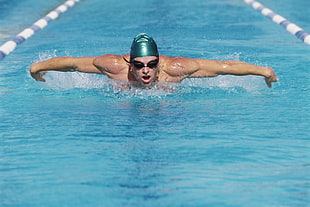 time lapse of swimmer man swimming during daytime