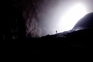 person in the entrance of cave