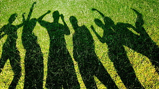 group of human silhouettes on green grass HD wallpaper