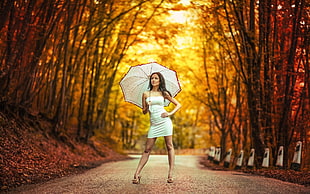 woman holding white umbrella