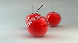 close up photo of three red cherries
