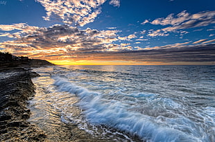 panoramic photo of sea under the blue sky during sunrise HD wallpaper
