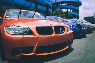 close up photo of orange BMW car at daytime