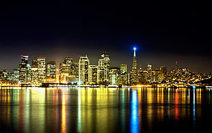 cityscape by the water at night HD wallpaper