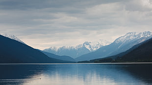 body of water between mountains landscape photography
