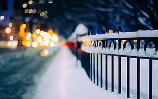 metal fence covered with snow