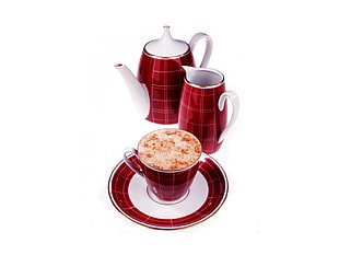 red ceramic teapot, pitcher, cup, and saucer set