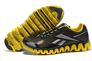 pair of yellow-and-black Reebok running shoes HD wallpaper