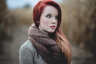 closeup photo of a woman wearing brown shawl and gray knit sweater