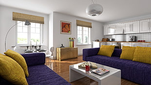 two purple suede sofas with five yellow throw pillows