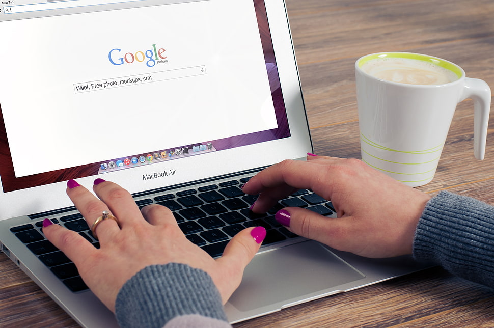 MacBook Air beside white ceramic coffee mug HD wallpaper