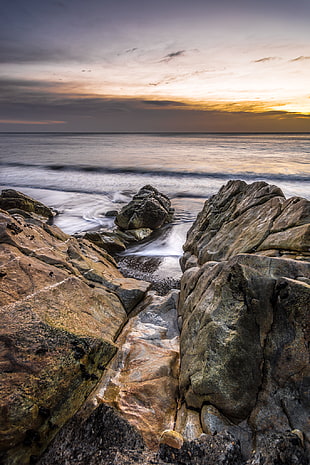 brown and gray rock formation beside sea shore, white rock, dalkey, dublin, ireland HD wallpaper