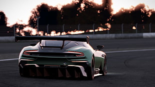 green and black sports car on concrete road
