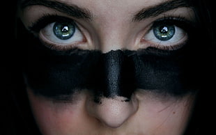 close-up photo of person with black paint on face