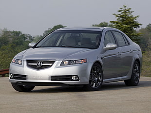 silver Acura TL on pavement during daytime