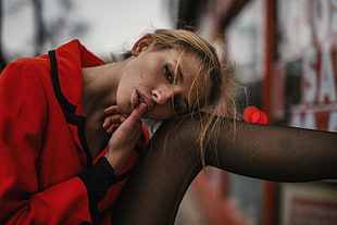 woman wearing red and black collared long-sleeved top