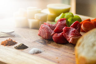 selective focus photo of raw meat on brown surface