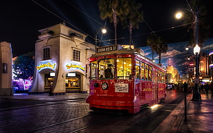 red city tram during nighttime
