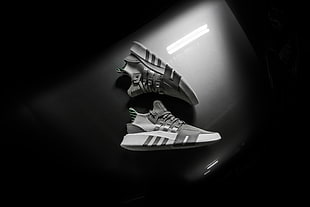 pair of gray-and-black Adidas low-top sneakers
