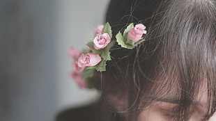person wearing pink rose flowers in top of head