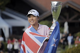 woman holding trophy and flag