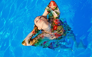 woman in floral tops at pool