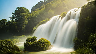 time-lapse photograph of waterfalls surrounded by trees