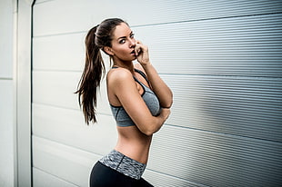 woman wearing gray and black sports bra and shorts