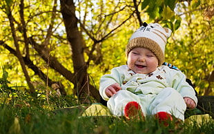 still life photo of baby sitting on grass HD wallpaper