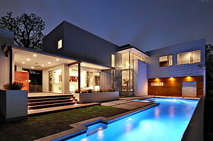 white and black concrete house with swimming pool