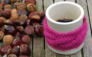 white ceramic coffee cup with brown nuts