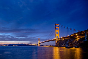 bridge under blue ocean during sunset HD wallpaper