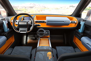 gray Toyota steering wheel and orange and gray dashboard