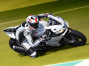man riding on white and black sports bike making a racee HD wallpaper