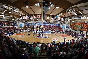 two basketball teams playing on court