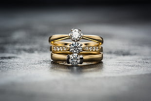 diamond encrusted gold-colored ring