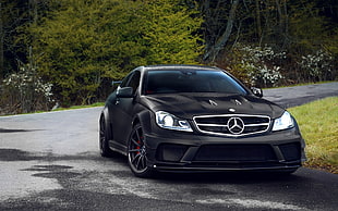 black Mercedes Benz coupe on road